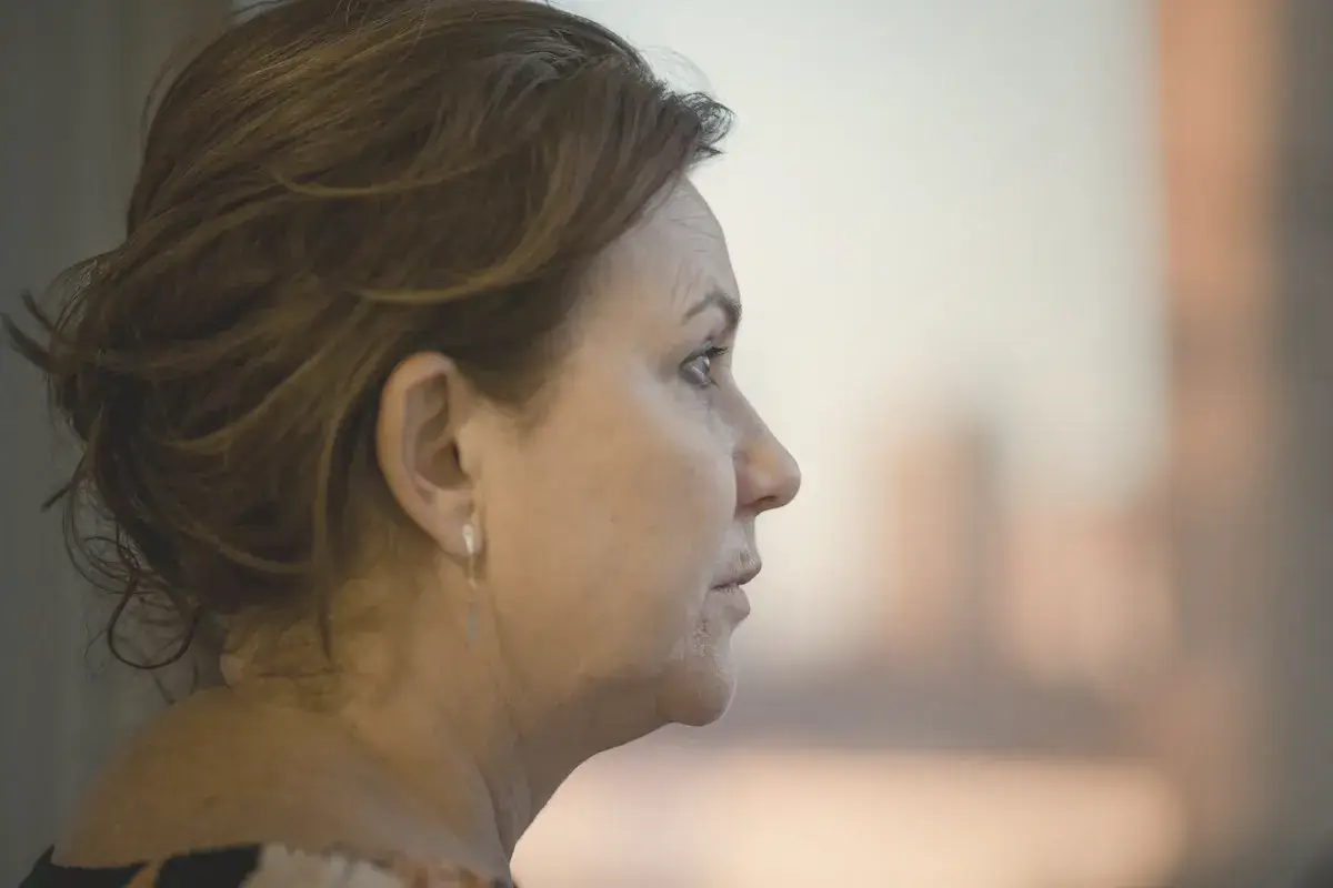 A close up of a person with a city in the background