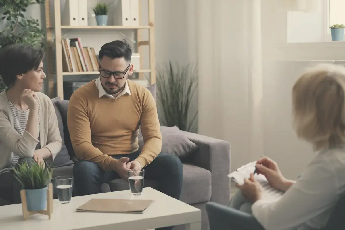A group of people sitting around a living room
