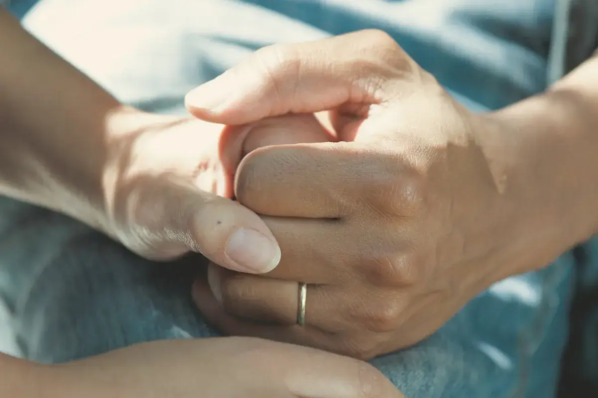 Person wearing gold wedding band