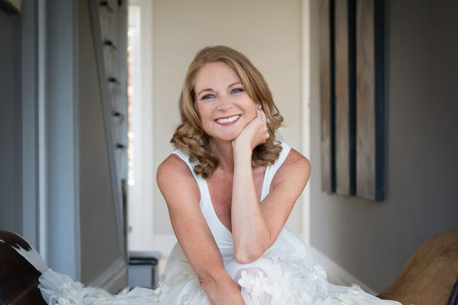 Personal stylist Johanna-May smiling, seated in a white dress