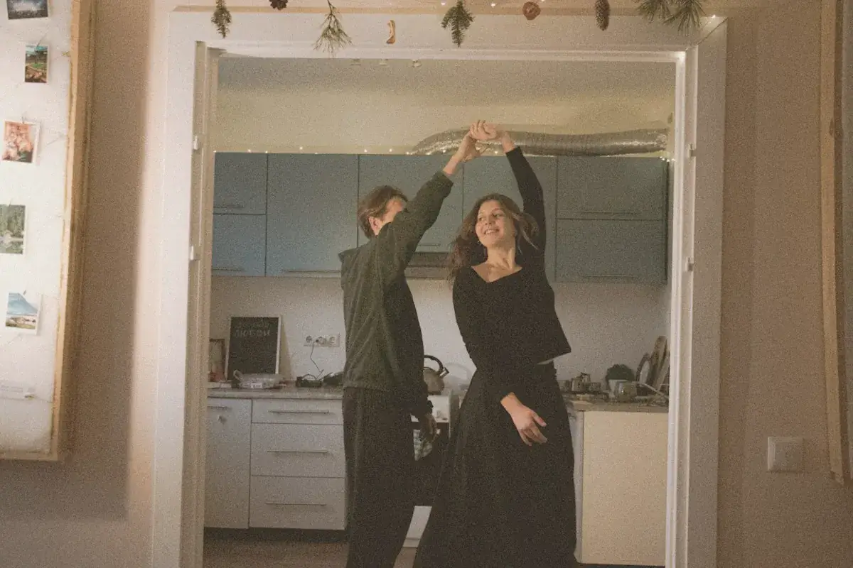 Couple dancing in a kitchen doorway