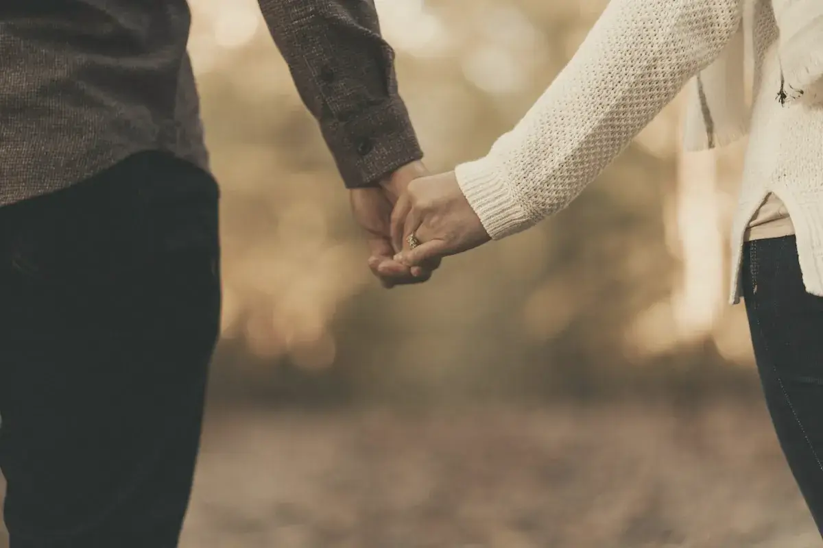 Woman and man holding hands