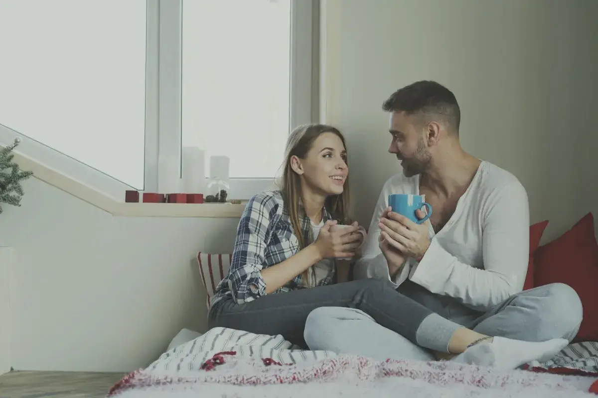 Couple enjoying drinks by the window