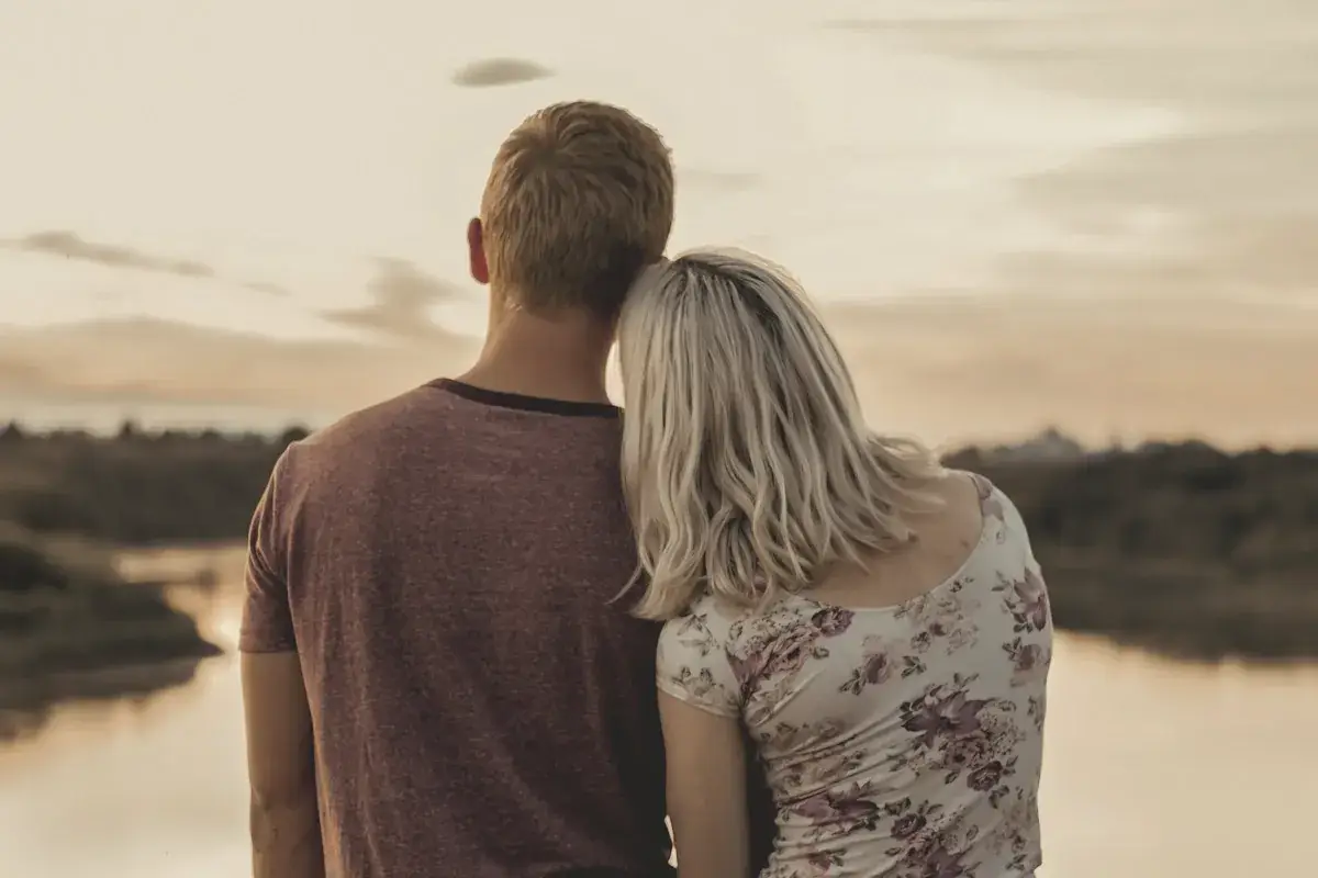 Man and woman standing on brown field during daytime
