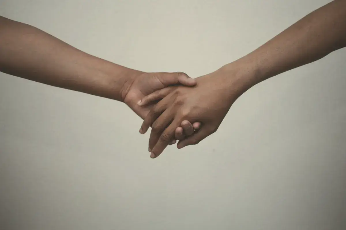 Persons hand on white surface