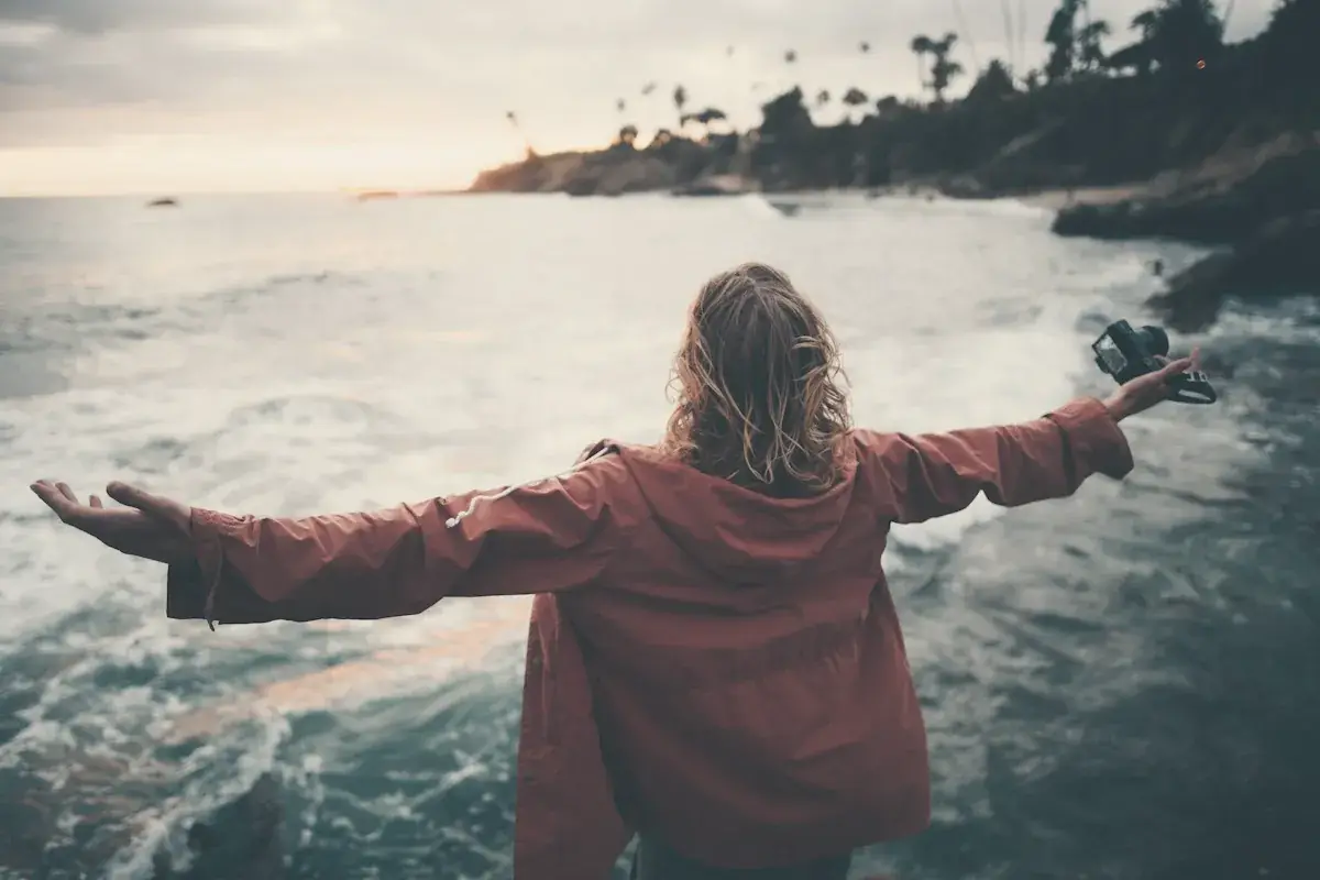 Person standing near body of water
