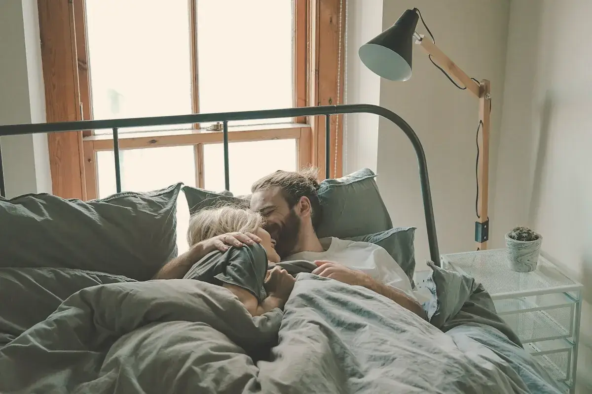 Man kissing woman on her forehead