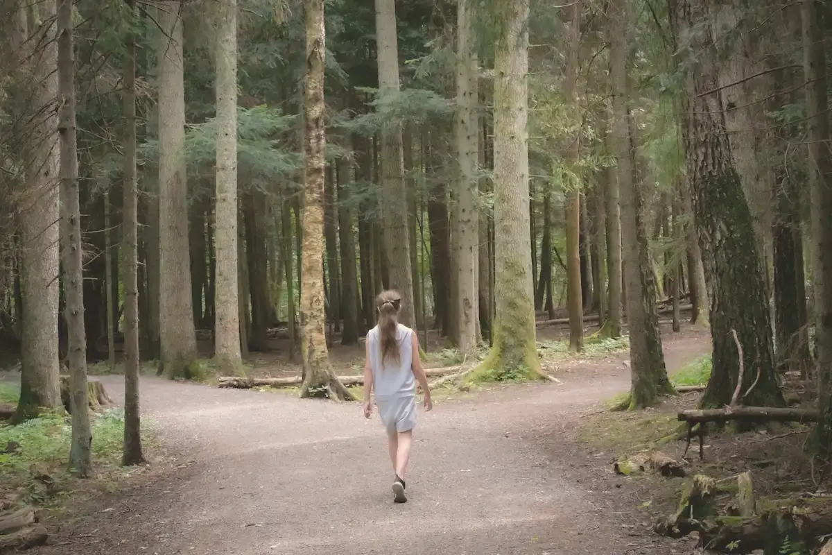 Girl walking near trees