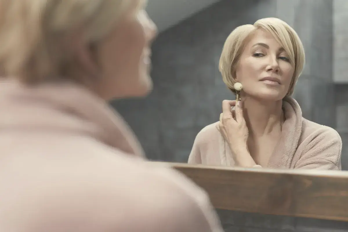 Mature woman looking at herself in the mirror