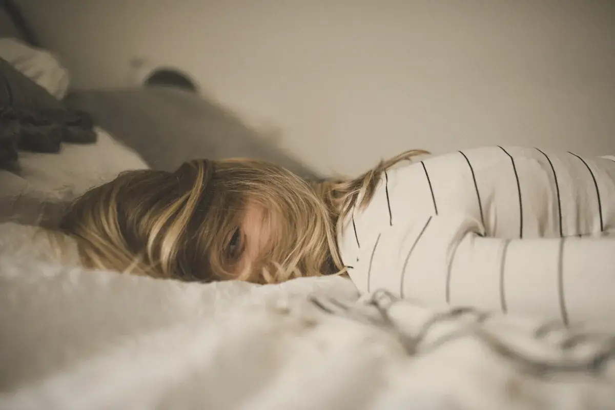 Woman lying on bed