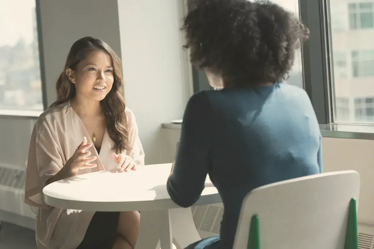Two women sitting on chair